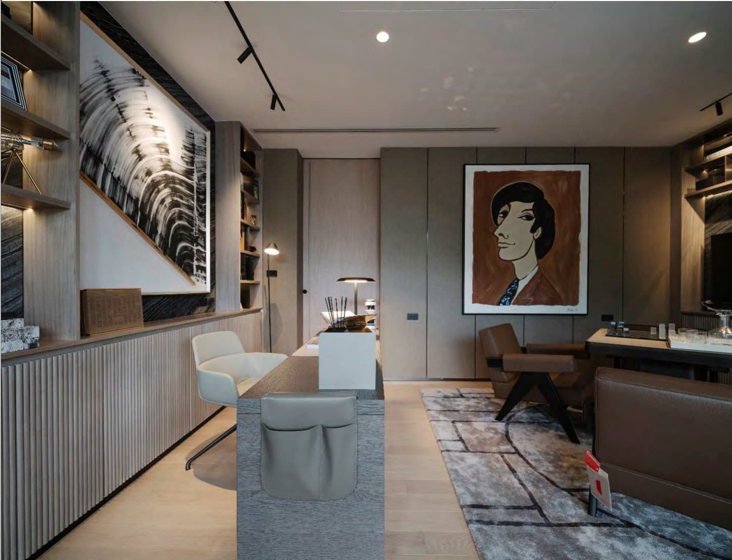 Gallery-like study with black-and-white brushstroke canvas, a bold figurative portrait, fluted timber joinery and tan leather armchairs on a soft rug